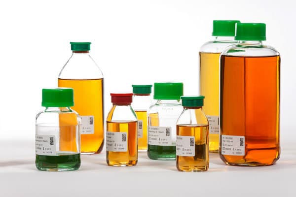 Bottles of prepared culture media in a range of sizes and colours.