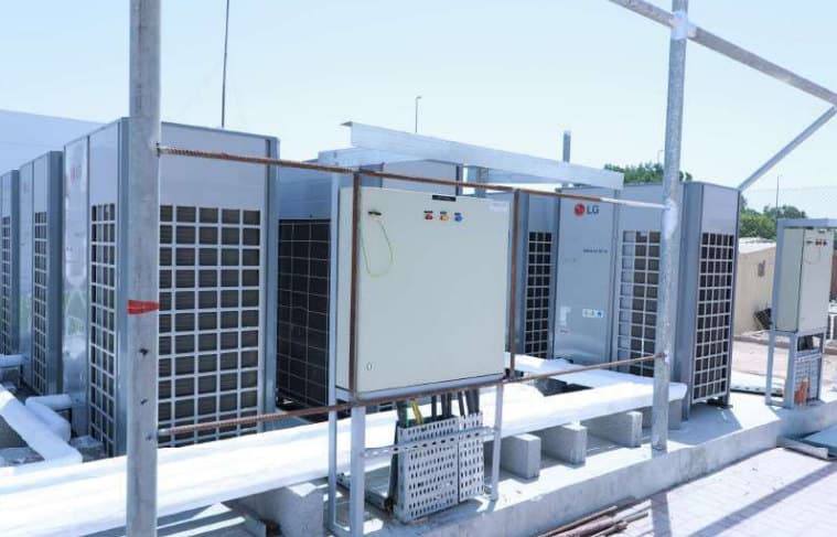 A rooftop array of HVAC condenser units serving a pharmaceutical facility.